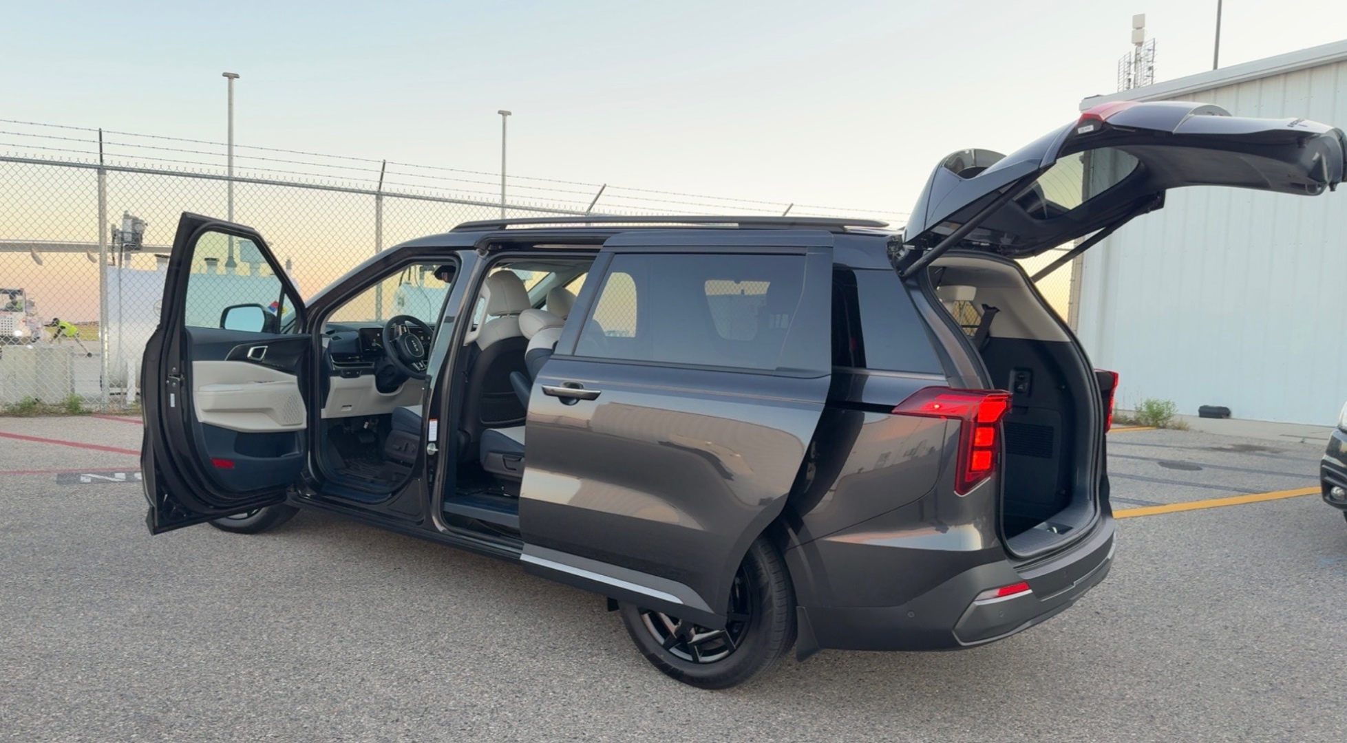 Ellis Transit minivan parked at airport at dusk, doors open